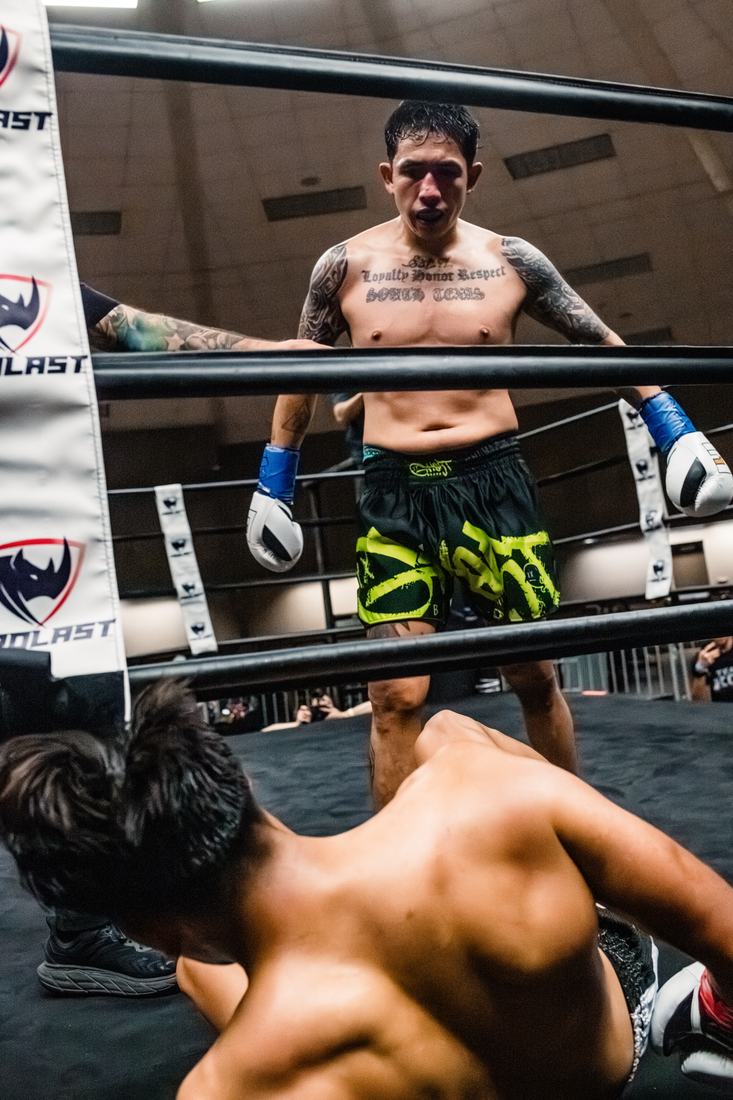 Fighter standing over a knocked-down opponent