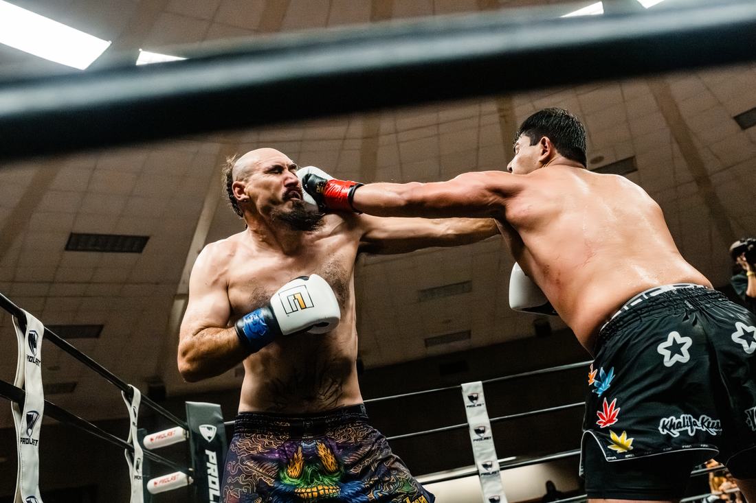 A punch landing on a fighter's face inside the ring