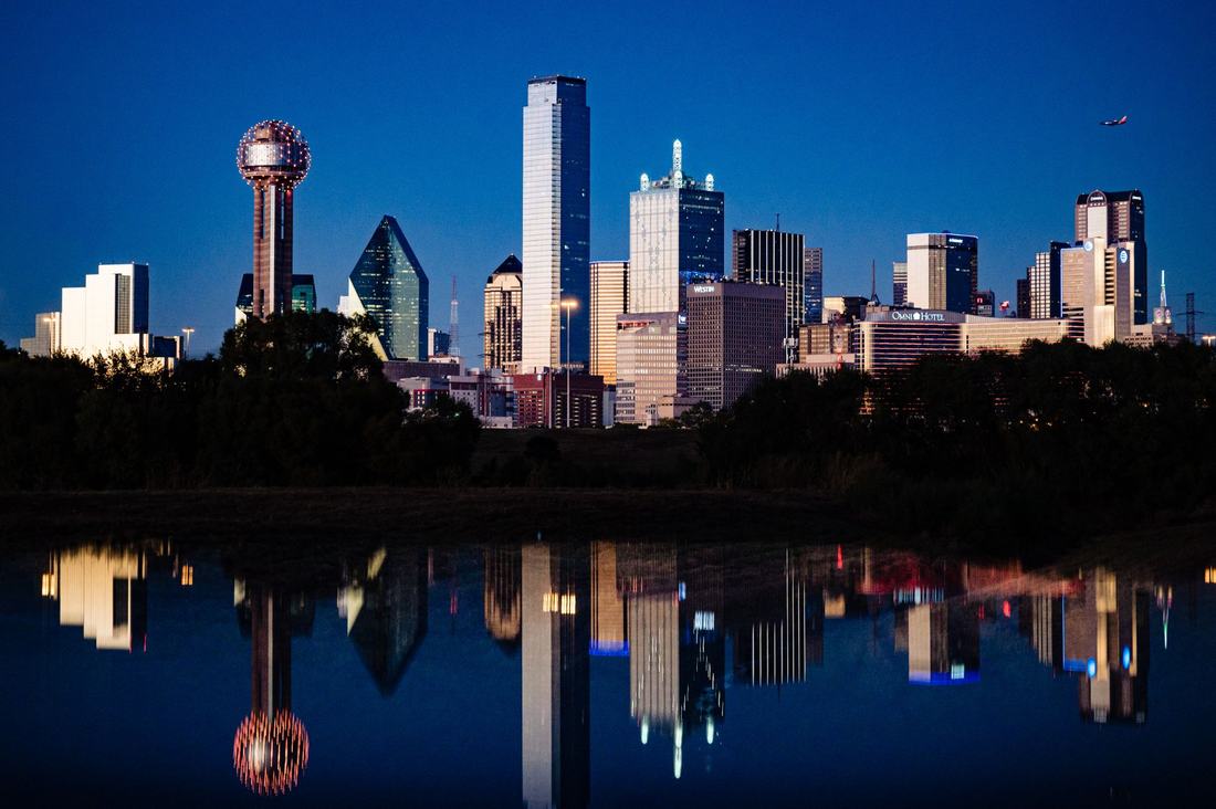 Dallas skyline at blue hour reflected in still water